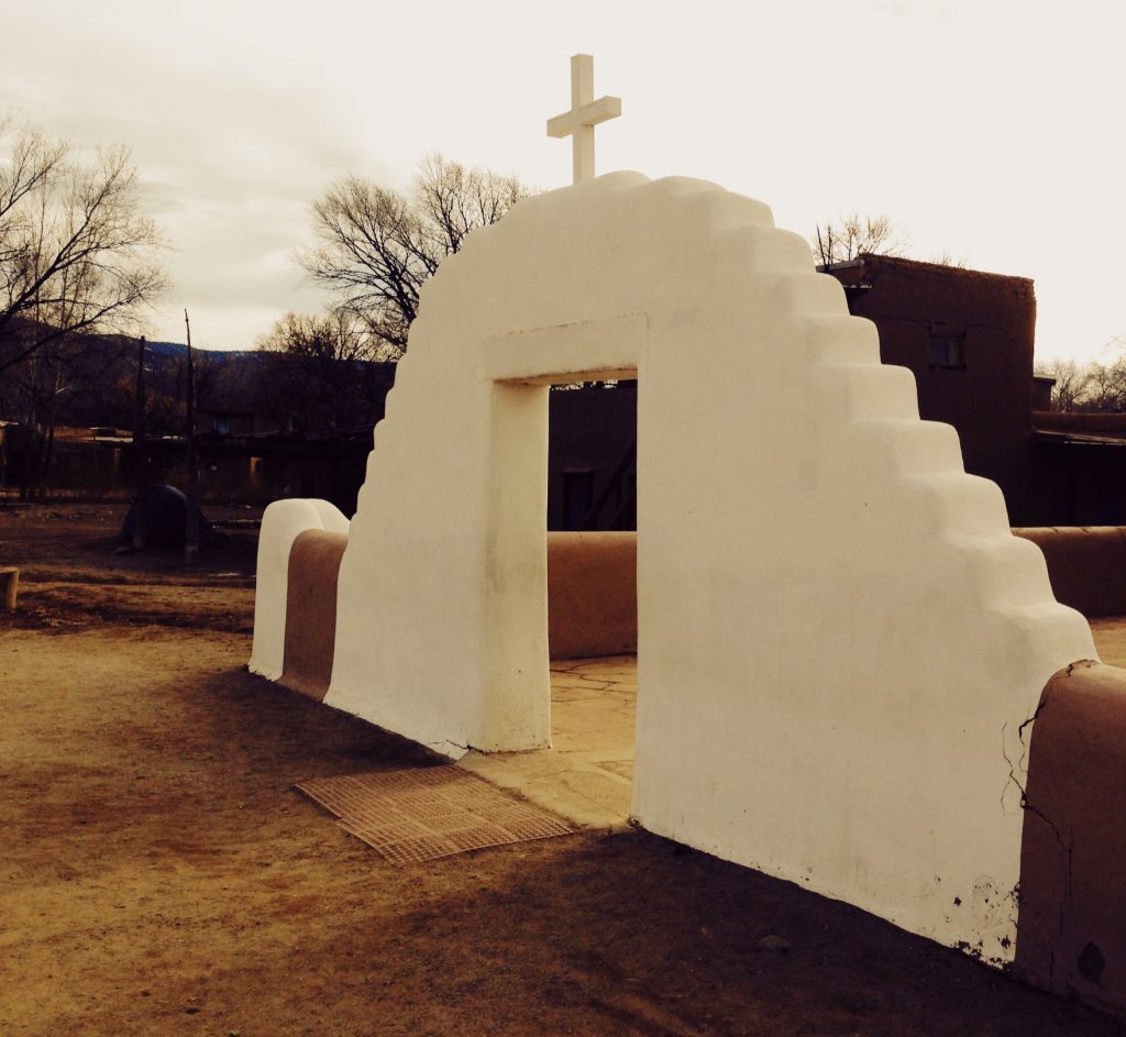 Desert white cross entrance - Taos Pueblo